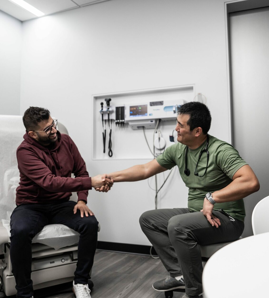 a Crossover Health primary care provider meeting with a Crossover member in an exam room at the Crossover San Tomas location