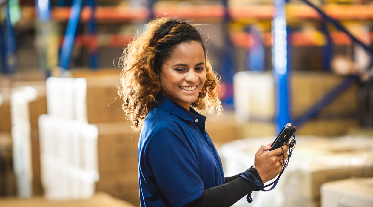 female warehouse worker happily doing her work