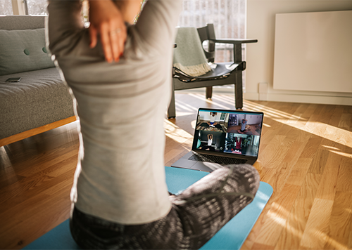 Woman participating in virtual fitness class