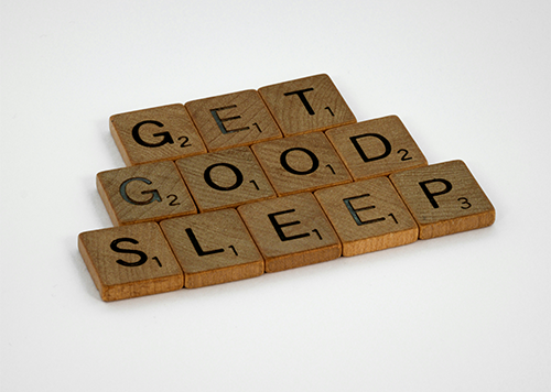 Scrabble tiles spelling "GET GOOD SLEEP"